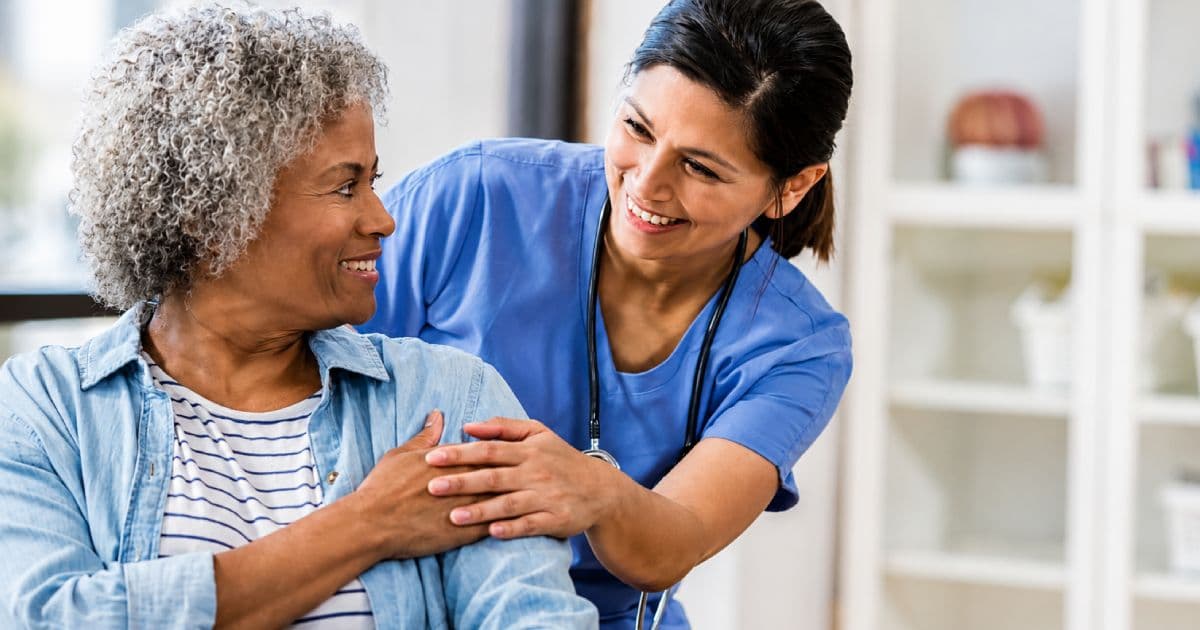 Nurse calmly speaking with a patient during a difficult conversation